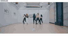 a group of women are dancing in a dance studio with the words vine entertainment on the wall