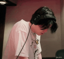 a person wearing a pair of headphones with the letter b on them