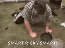 a man is doing push ups on the floor while a dog looks on .