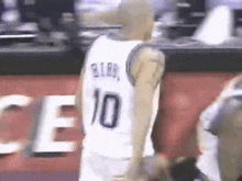 a basketball player wearing a white jersey with the number 10 on the back