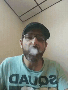 a man with a beard wearing a shirt that says gauq2
