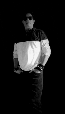 a man wearing sunglasses and a white and black shirt