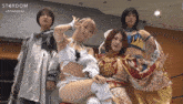 a group of female wrestlers posing for a photo with the hashtag stardom