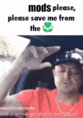a man is sitting in a car holding a cell phone and asking for mods to save him