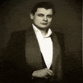 a black and white photo of a man in a tuxedo with russian writing on it
