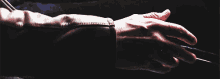 a close up of a person 's hand with the word x-men written below it