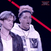 a man with his mouth open stands next to another man
