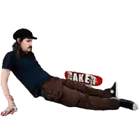 a man is laying on the floor with a skateboard that says baker on it