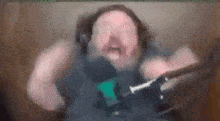 a blurry picture of a man wearing headphones and holding a microphone