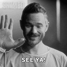 a man in a hospital gown is smiling and says see ya