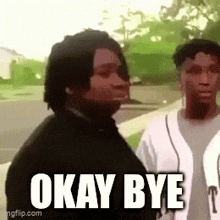 a man is standing next to another man with the words `` okay bye '' written on his face .