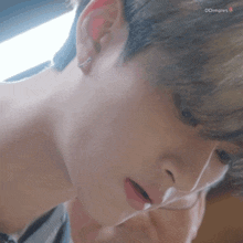 a close up of a person 's face with a ring in their ear
