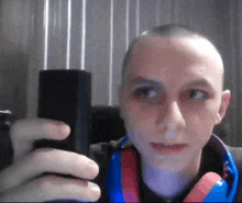 a man is taking a picture of himself with his phone