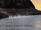 a large body of water is surrounded by rocks