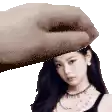 a hand is holding a woman 's head in a pixel art image .