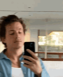 a man is taking a picture of himself with his phone