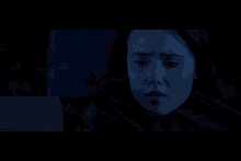 a person wrapped in a blue blanket laying on a bed
