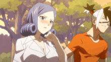 a man in an orange shirt stands next to a woman with purple hair