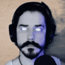 a man with a beard is wearing headphones and a microphone