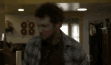 a blurry picture of a man standing in a living room with a window .