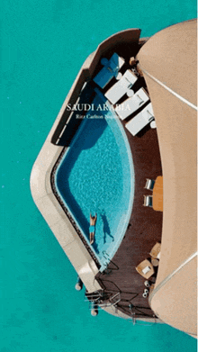 an aerial view of a man swimming in a pool with the words saudi arabia at the bottom