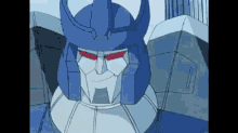 a close up of a cartoon robot with a blue helmet and red eyes .