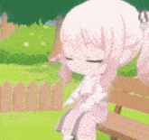 a little girl is sitting on a bench in a park with her eyes closed .