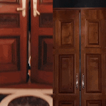 a woman in a black dress is peeking out from behind a pair of wooden doors
