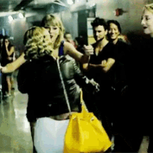 a group of people are dancing in a dark room