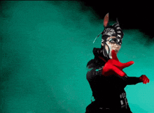 a woman in a costume with red gloves is making a gesture