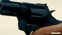 a close up of a person holding a gun with the hashtag #sfirncgun