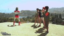a group of people standing on top of a hill with the website funnyordtee.com in the corner