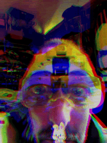 a blurry picture of a man 's face with a rainbow background