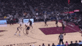 a basketball game is being played in front of a rocket mortgage house sign