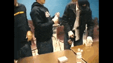 a group of people standing around a table with a man wearing a hat that says ' jacksonville ' on it