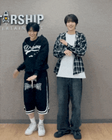 two men standing in front of a sign that says starship entertainment