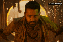 a man with a beard is standing in front of a circle of fire and a sign that says x7wickreddy