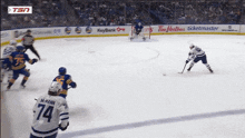 a hockey player with the number 74 on his jersey stands on the ice