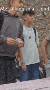 a group of young men are talking to a friend