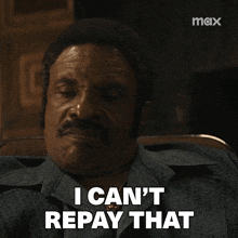 a man with a mustache says i can 't repay that in front of a max logo