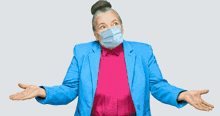 a woman wearing a face mask is shrugging her shoulders in front of an empty shelf