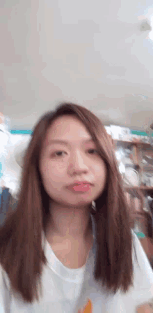 a woman with long hair is making a funny face with her tongue out
