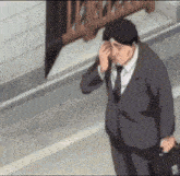a man in a suit and tie is walking down a street