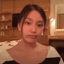 a young woman is making a funny face in a room