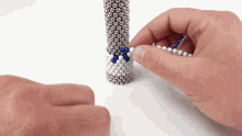 a person is playing with a stack of magnets