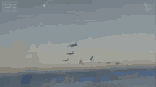 an aerial view of an airplane flying through the clouds with a blue sky in the background