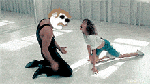a man is kneeling down next to a woman who is stretching her legs