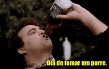 a man is drinking from a bottle of jack daniels