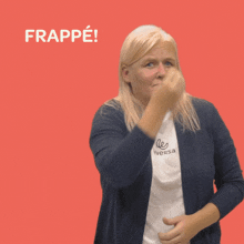 a woman covering her face with her hand in front of a red background with the word frappe on it
