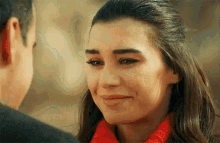 a man and a woman are looking at each other with the woman smiling